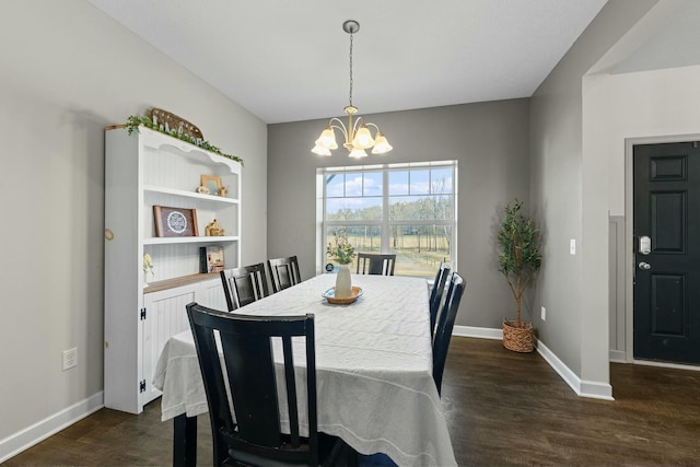 dining area featuring an inviting chandelier, baseboards, and dark wood-style flooring