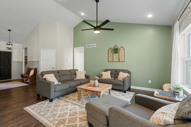 living room with visible vents, baseboards, ceiling fan, wood finished floors, and high vaulted ceiling