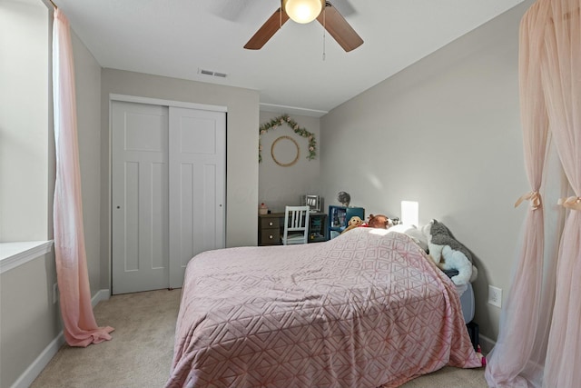 bedroom with visible vents, ceiling fan, baseboards, carpet, and a closet