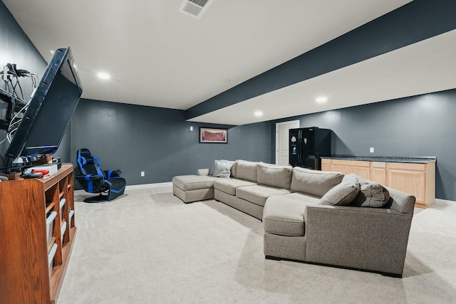 living room featuring recessed lighting, light colored carpet, visible vents, and baseboards