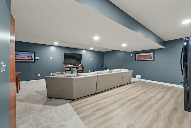 living room with recessed lighting, baseboards, and wood finished floors