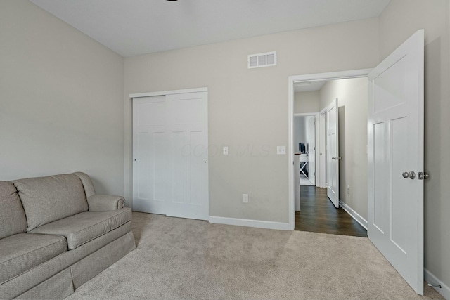 living room featuring dark colored carpet, visible vents, and baseboards