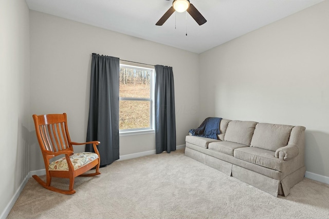 sitting room with carpet, a ceiling fan, and baseboards