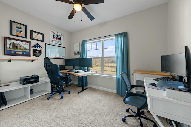 home office with a ceiling fan, baseboards, and carpet floors