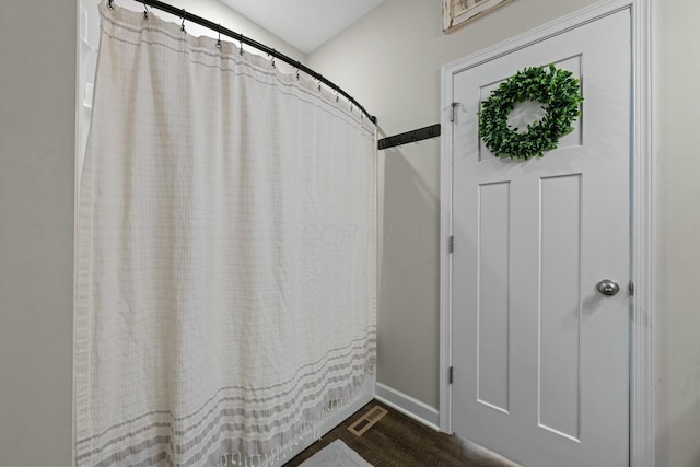 full bathroom featuring visible vents, baseboards, and wood finished floors