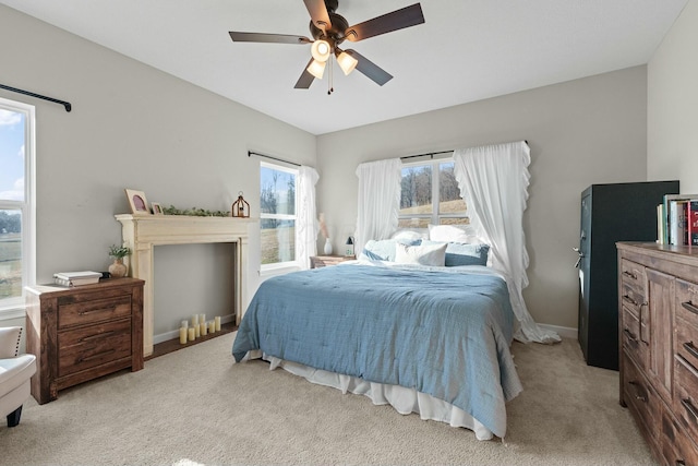 carpeted bedroom featuring baseboards and a ceiling fan