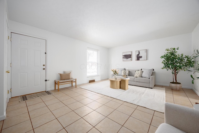 living room featuring light tile patterned floors and baseboards