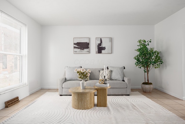 living area featuring tile patterned flooring, baseboards, and visible vents