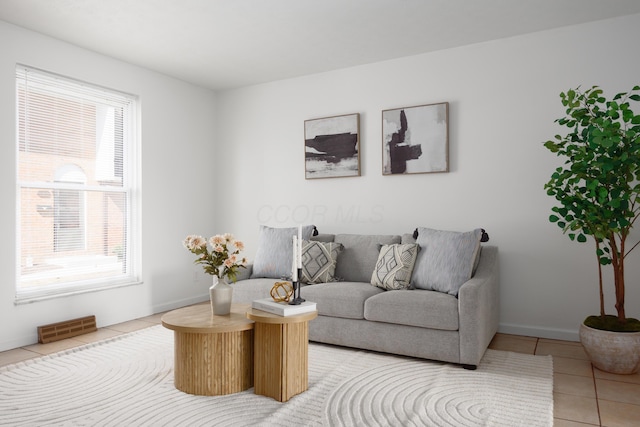 living room with light tile patterned floors and baseboards