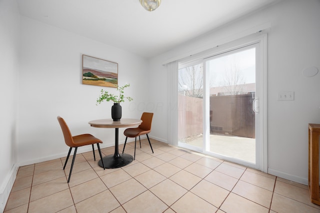 dining room featuring light tile patterned floors and baseboards