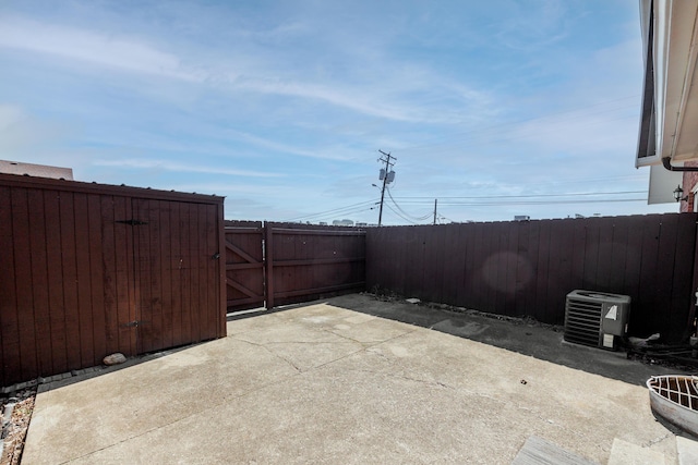 view of patio / terrace with a gate, cooling unit, and fence