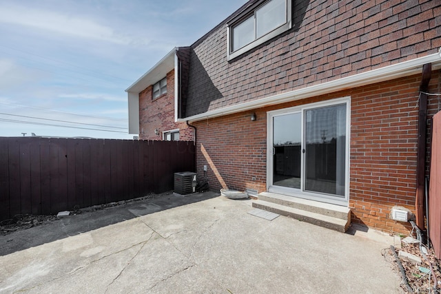 view of patio featuring central AC unit and fence