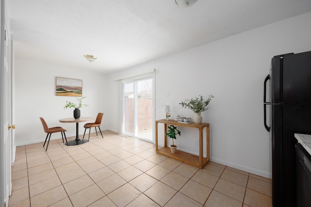 sitting room with light tile patterned floors and baseboards