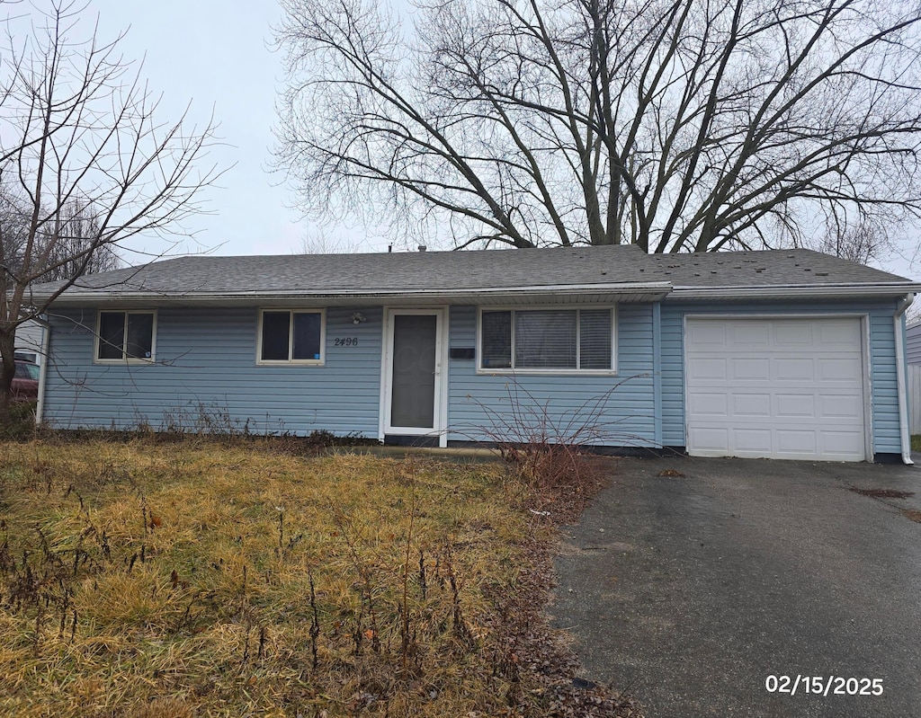 ranch-style house with driveway and an attached garage