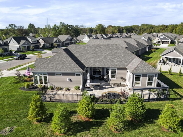 back of property featuring a residential view, a patio, a fenced backyard, and a shingled roof