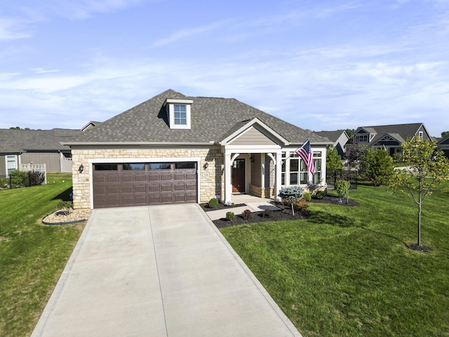 view of front of home featuring stone siding, roof with shingles, concrete driveway, and a front lawn