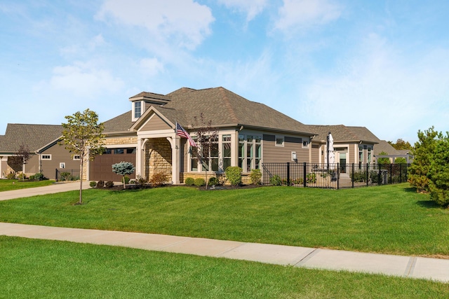 view of front of property with a front yard, an attached garage, fence, and driveway