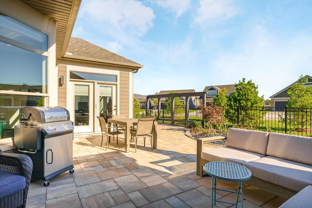 view of patio with an outdoor living space, outdoor dining area, fence, and a grill