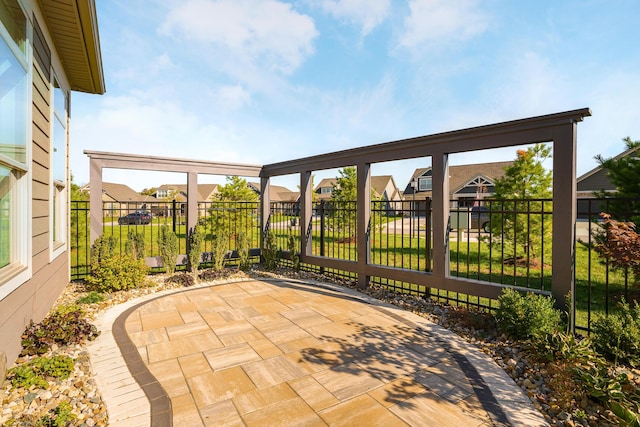 view of patio / terrace with a residential view and fence