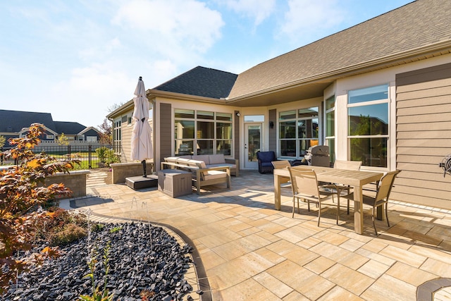 view of patio / terrace featuring an outdoor hangout area, outdoor dining space, and fence