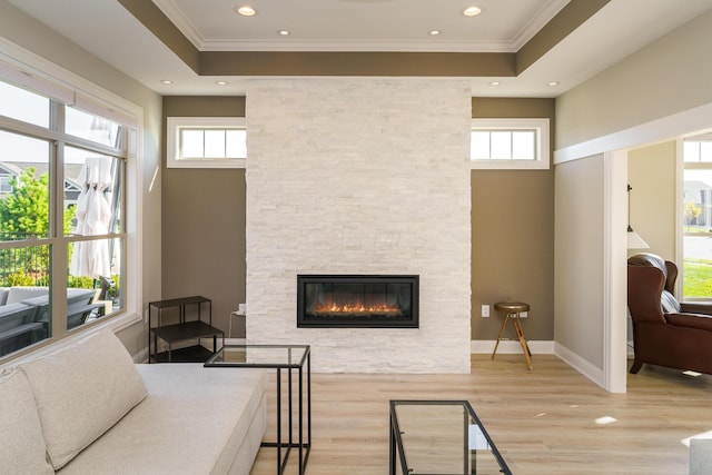 bedroom with multiple windows, wood finished floors, a fireplace, and ornamental molding