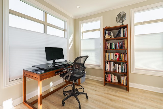 office space with light wood-style floors, baseboards, and ornamental molding