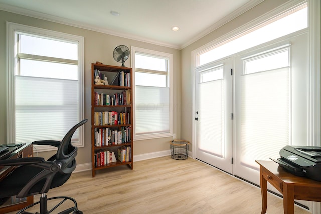 office featuring light wood-style flooring, crown molding, and baseboards