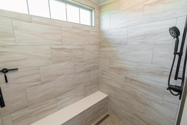 full bath featuring a tile shower