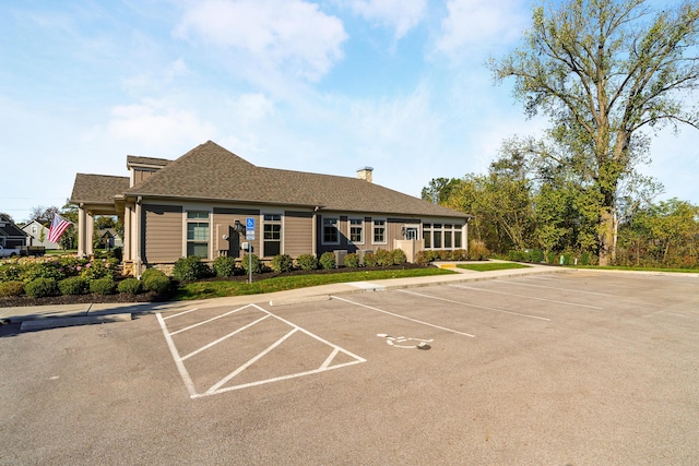 view of building exterior with uncovered parking