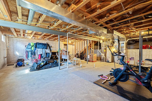 unfinished below grade area with gas water heater and brick wall