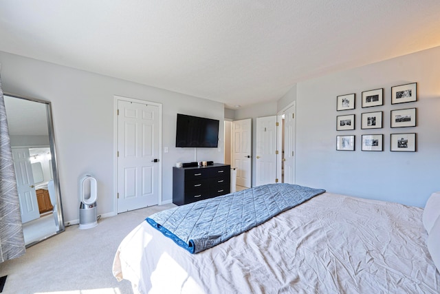 bedroom with light carpet and baseboards