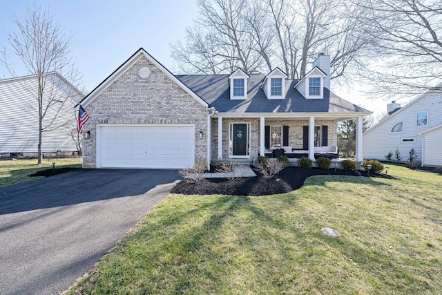 cape cod home with driveway, a porch, a garage, brick siding, and a chimney