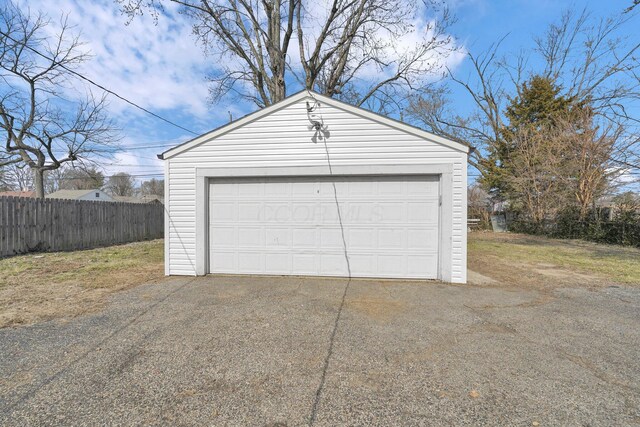 detached garage featuring fence