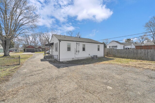 back of house with cooling unit, fence, and crawl space