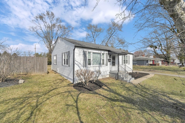 view of front of property featuring a front lawn and fence