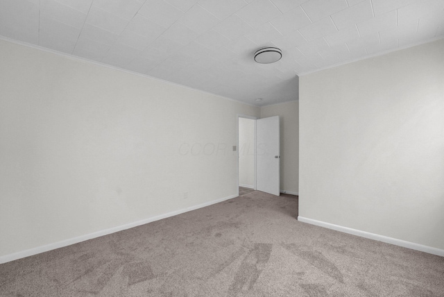 unfurnished room with baseboards and carpet flooring