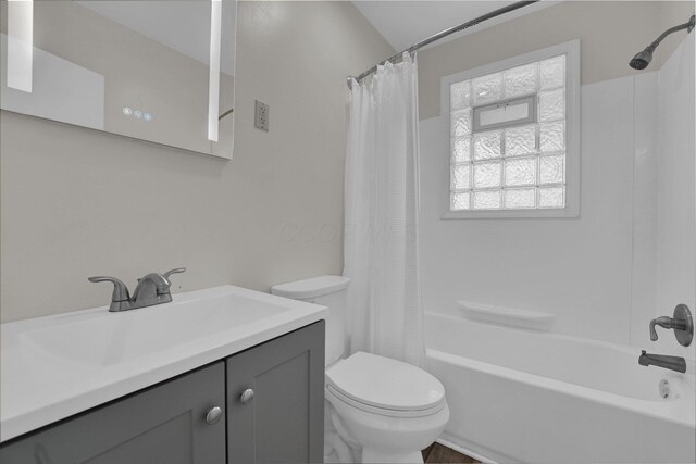 full bathroom featuring vanity, toilet, and shower / tub combo with curtain