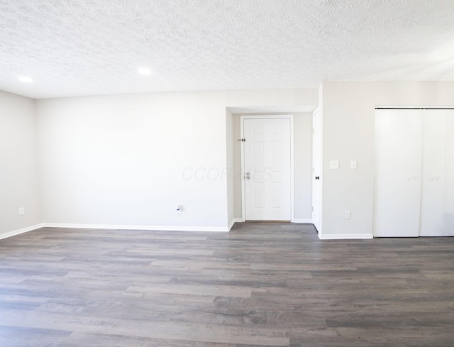 unfurnished bedroom with a closet, baseboards, and wood finished floors