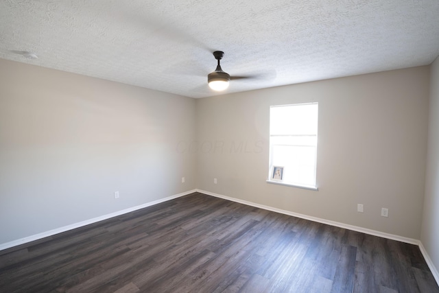 unfurnished room with a textured ceiling, baseboards, ceiling fan, and dark wood-style flooring