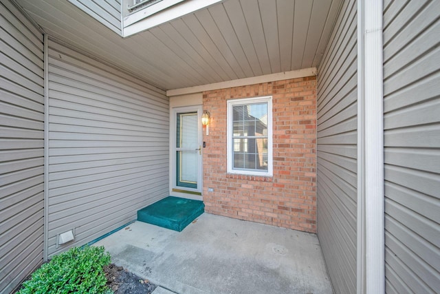 property entrance featuring brick siding