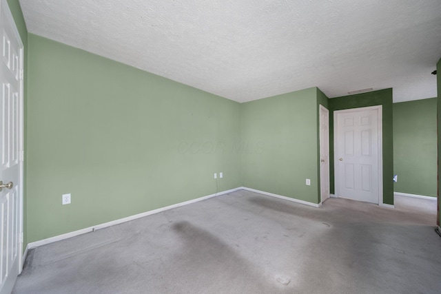 unfurnished bedroom featuring carpet, baseboards, and a textured ceiling