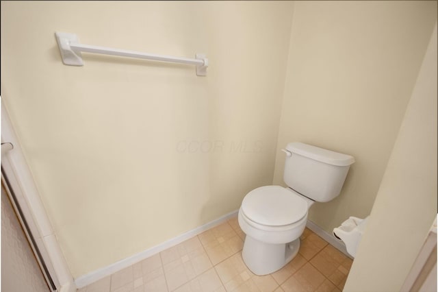 bathroom with toilet and baseboards