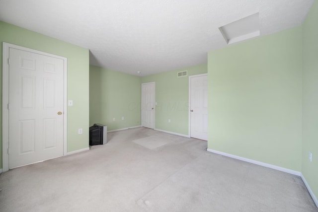 interior space featuring attic access, baseboards, and visible vents