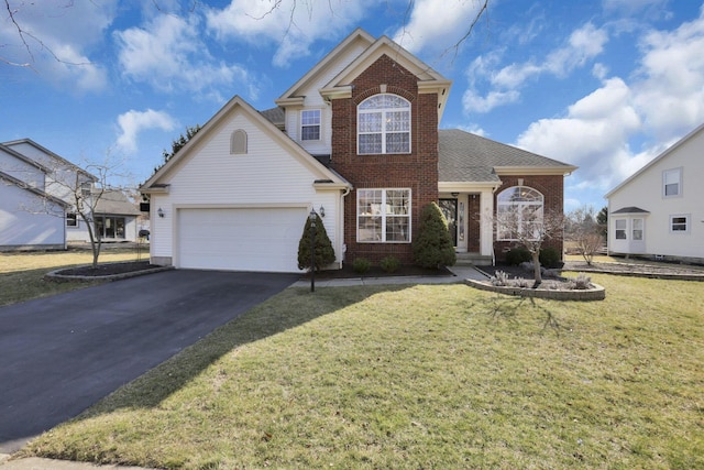 traditional-style home with a front lawn, an attached garage, brick siding, and driveway