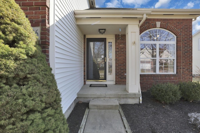 property entrance with brick siding