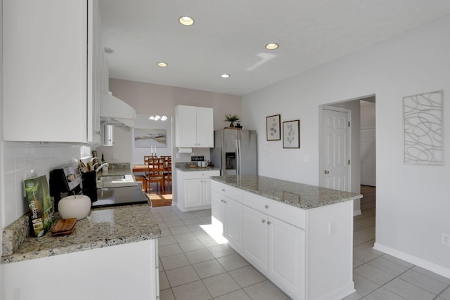 kitchen featuring a sink, a kitchen island, white cabinetry, recessed lighting, and stainless steel fridge with ice dispenser