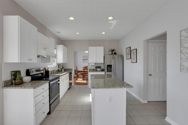 kitchen featuring a kitchen island, under cabinet range hood, stainless steel appliances, light tile patterned flooring, and white cabinetry