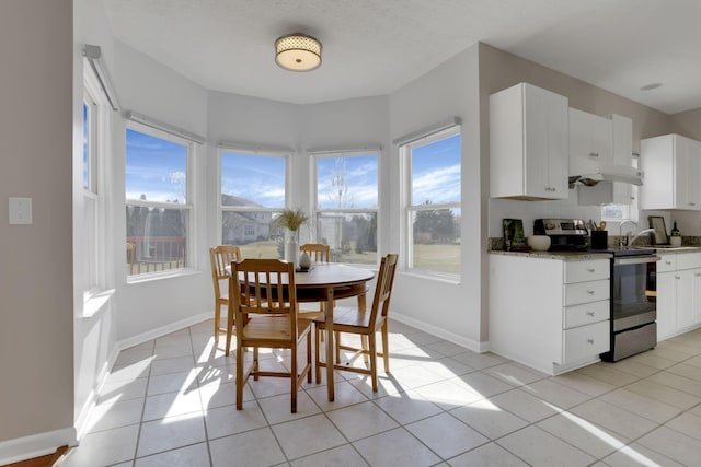 dining room with light tile patterned floors and baseboards