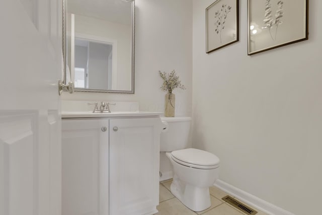 bathroom with tile patterned flooring, visible vents, baseboards, toilet, and vanity