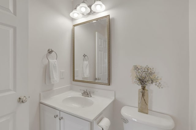 bathroom featuring toilet and vanity